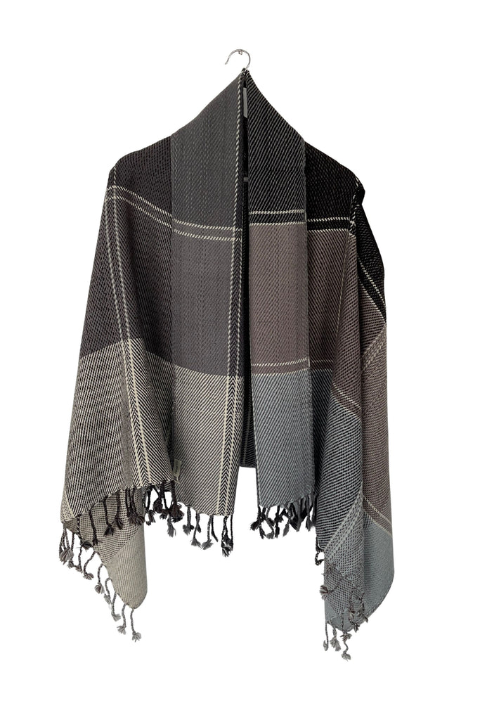 A sepia-toned grey wool plaid cape tartan weave with tassles