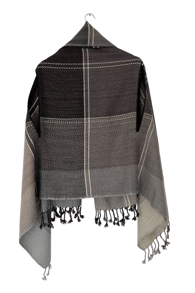 A sepia-toned grey wool plaid cape tartan weave with tassles
