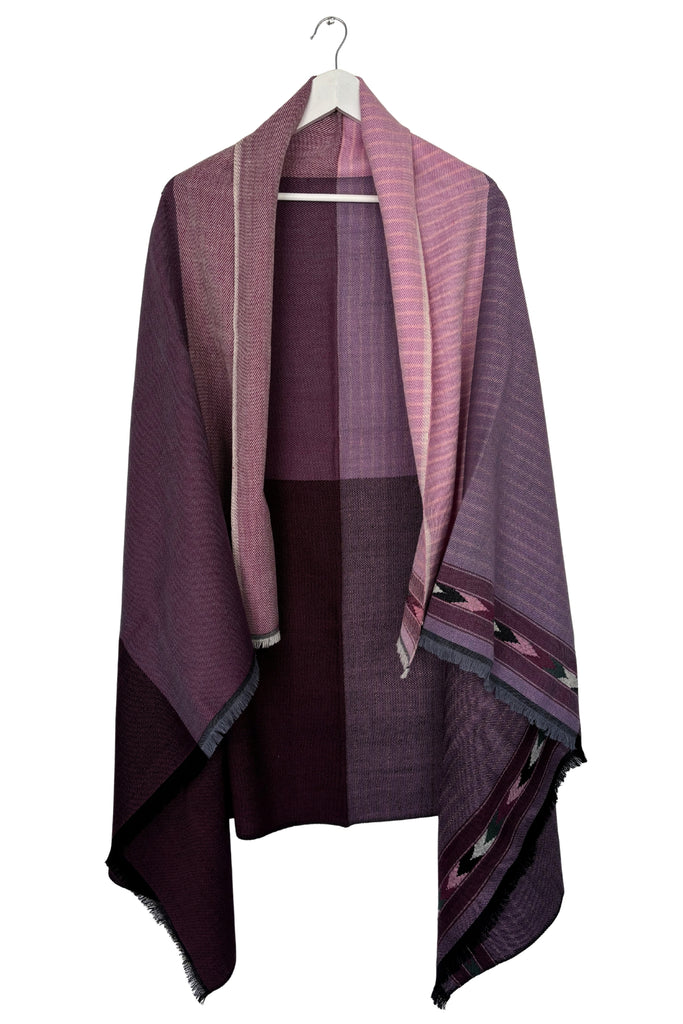 Purple and pink patti patterned Cape draped over a garment on a white background
