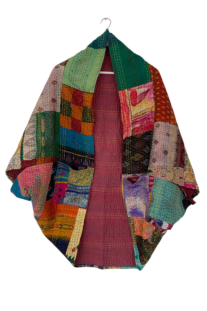 Multicolored patchwork shrug on a white background