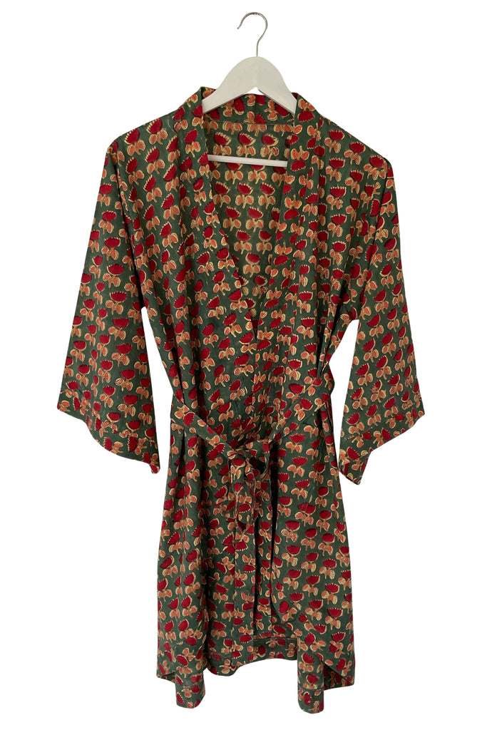 Floral patterned dress on a hanger against a white background