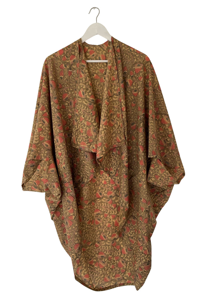 Patterned kimono draped over a hanger on a white background