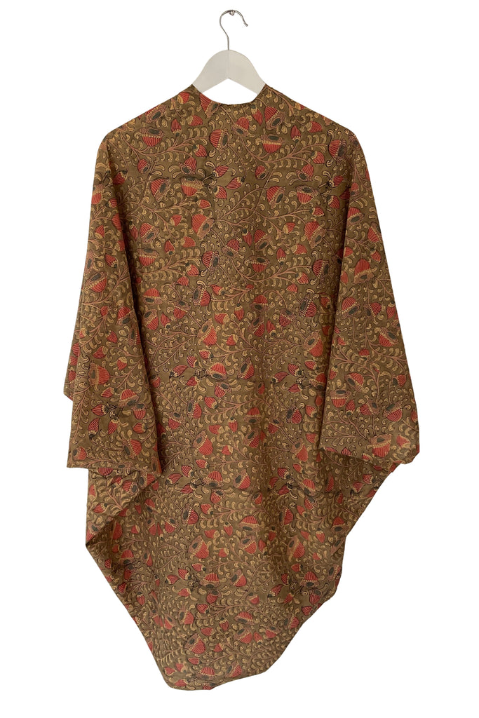 Brown and red patterned garment on a hanger against a white background
