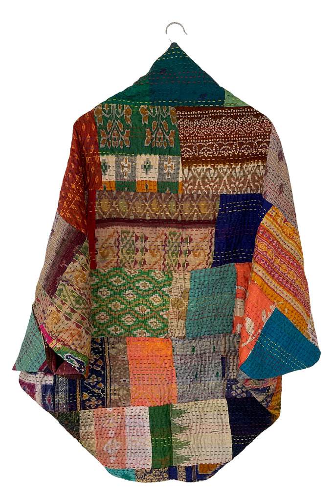 Multicolored patchwork jacket on a hanger against a white background