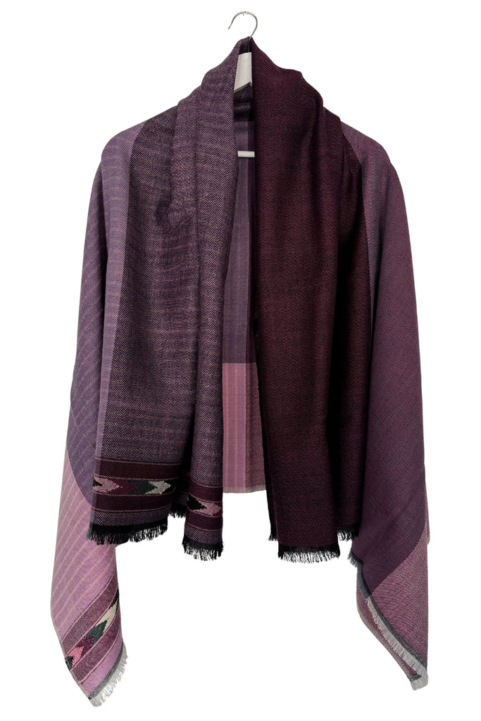 Purple cape with patterned edges on a white background