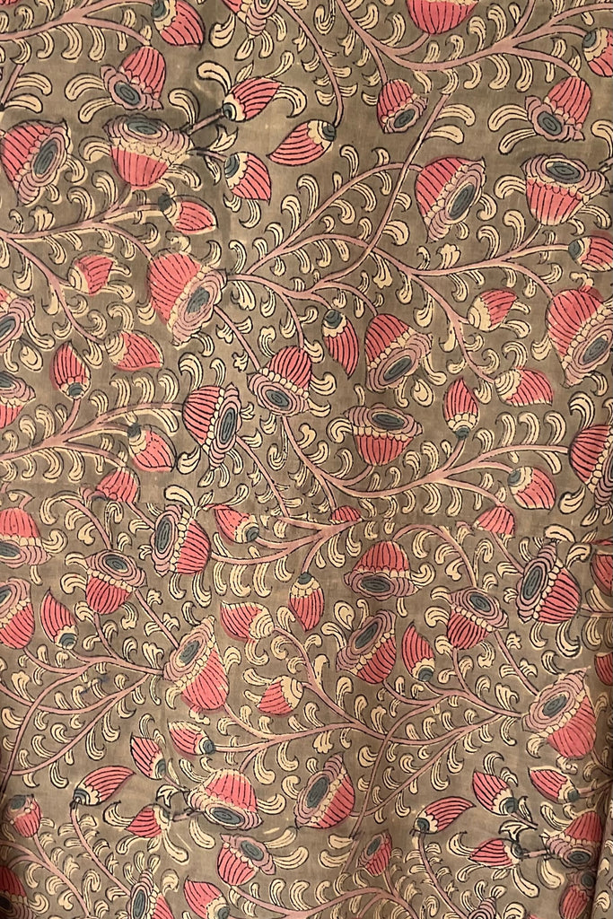 Patterned fabric with red and black floral design on a beige background