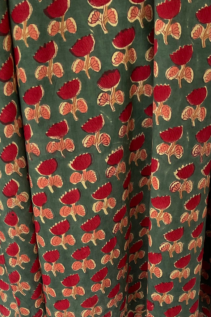 Green fabric with red and orange floral pattern