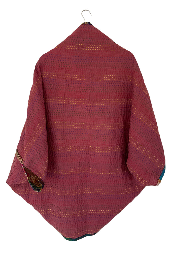 Red patterned fabric draped over a hook on a white background