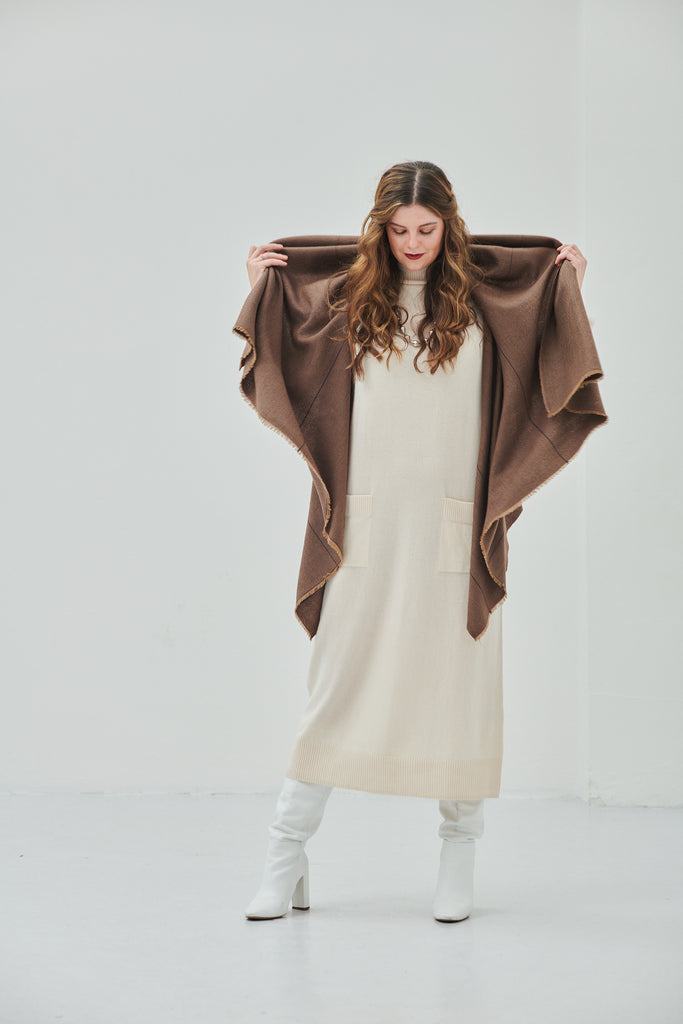 Shop luxury women's wool poncho cape in camel colours to be styled in 15-in-one ways and perfect as a warm sylish sustainable clothing item for layering