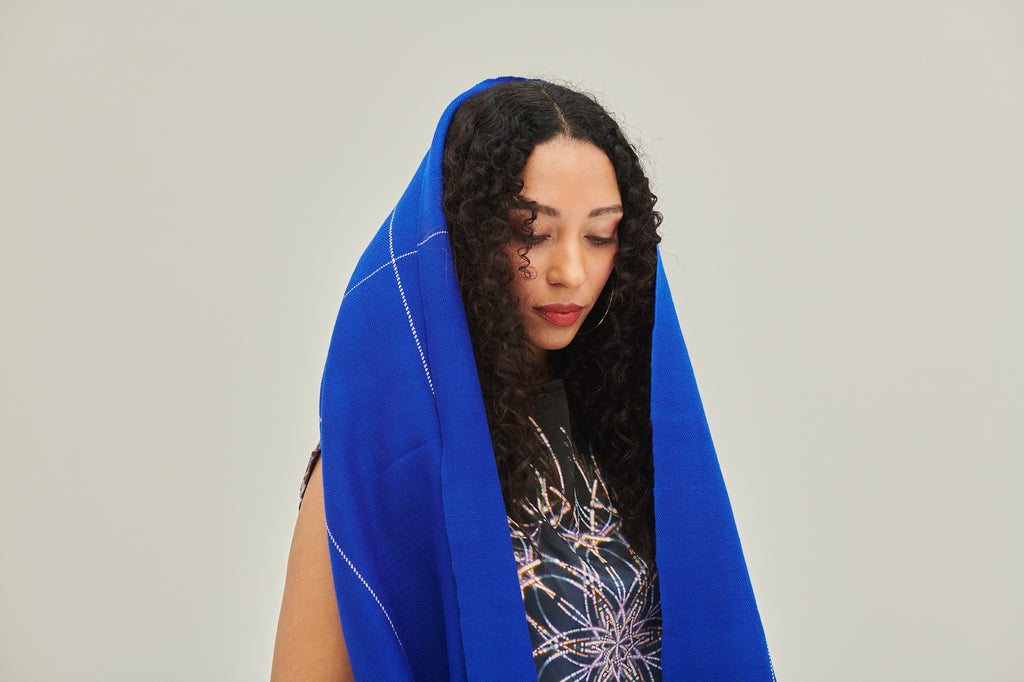 Wear the soft and graceful bright blue Cape Dia as a hoodie 